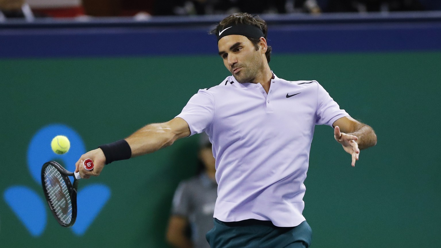 Roger Federer of Switzerland hits a forehand shot against Richard Gasquet of France during their men&#039;s singles quarterfinals match in the Shanghai Masters tennis tournament at Qizhong Forest Spor ...