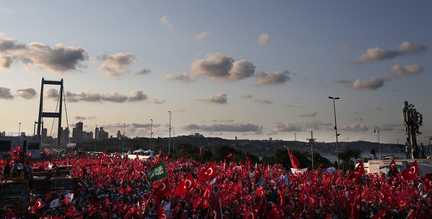 People gather near the July 15 Martyr&#039;s bridge on a &quot;National Unity March&quot; to commemorate the one year anniversary of the July 15, 2016 botched coup attempt, in Istanbul, Saturday, July ...