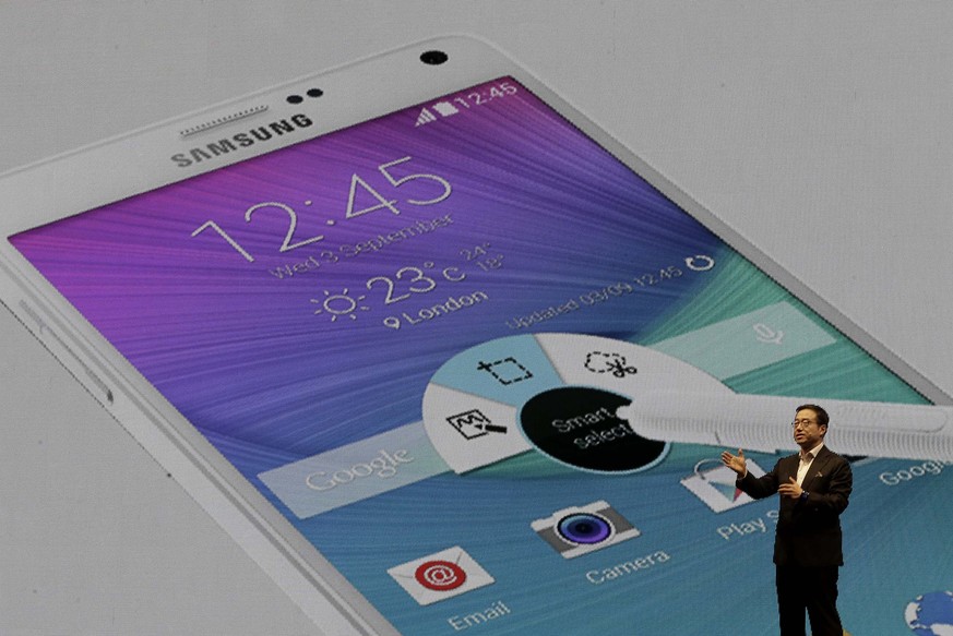 CORRECTS DATE - Lee Don-joo, head of sales and marketing for Samsung Electronics Co., introduces the latest Galaxy Note 4 during its unveiling in Seoul, South Korea, Wednesday, Sept. 24, 2014. Samsung ...