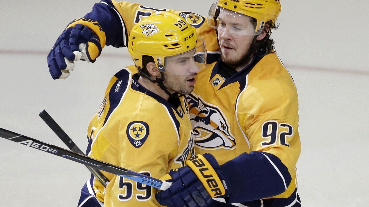 Nashville Predators defenseman Roman Josi (59), of Switzerland, is congratulated by Ryan Johansen (92) after Josi scored a goal against the Colorado Avalanche during the third period of an NHL hockey  ...