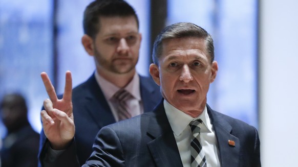 FILE- In this Nov. 17, 2016, file photo, retired Lt. Gen Michael Flynn gestures as he arrives with his son Michael G. Flynn, left, at Trump Tower in New York. Michael G. Flynn tweeted about the false  ...