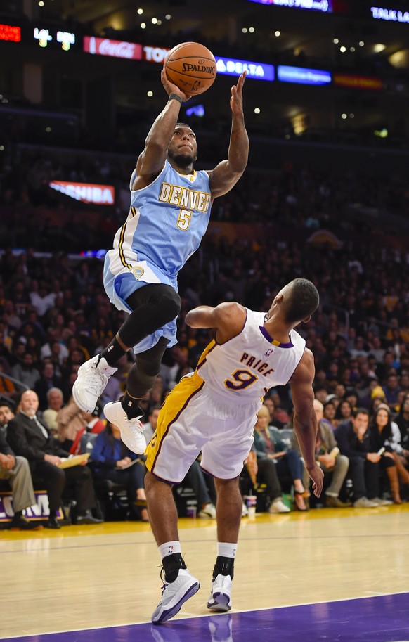 Denver Nuggets guard Nate Robinson (5) drives on Los Angeles Lakers guard Ronnie Price (9) as he drives to the basket in the second half of an NBA basketball game, Sunday, Nov. 23, 2014, in Los Angele ...