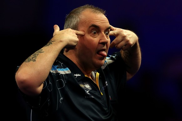 LONDON, ENGLAND - JANUARY 02: Phil Taylor of England reacts after winning a set during his quarter final match against Vincent van der Voort of the Netherlands on day twelve of the 2015 William Hill P ...