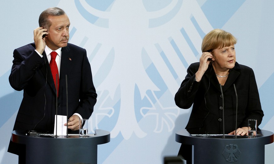 FILE - In this Oct. 31, 2012 file photo German Chancellor Angela Merkel, right, and Turkey&#039;s Prime Minister Recep Tayyip Erdogan, left, address the media during a joint press conference after a m ...