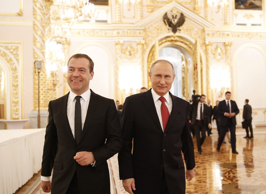 epa05654921 Russian Prime Minister Dmitry Medvedev (L) and Russian President Vladimir Putin (R) walk together after President&#039;s annual address to the Federal Assembly at the Kremlin in Moscow, Ru ...
