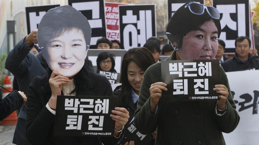 FILE - In this Nov. 18, 2016, file photo, protesters wearing masks of South Korean President Park Geun-hye, left and Choi Soon-sil, Park&#039;s longtime friend, in Seoul, South Korea. South Korean pro ...