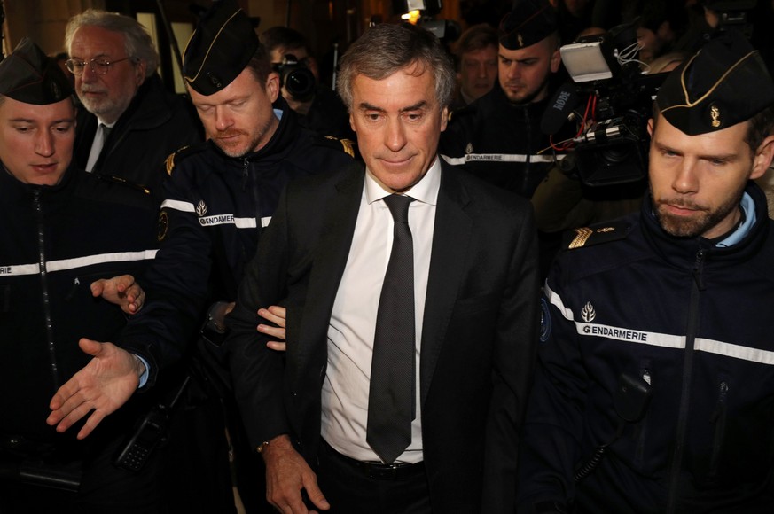 REFILE WITH CORRECTING HEADLINEFormer French budget minister Jerome Cahuzac, who resigned in 2013 after he admitted to having a Swiss bank account, is surrounded by French gendarmes as he leaves after ...