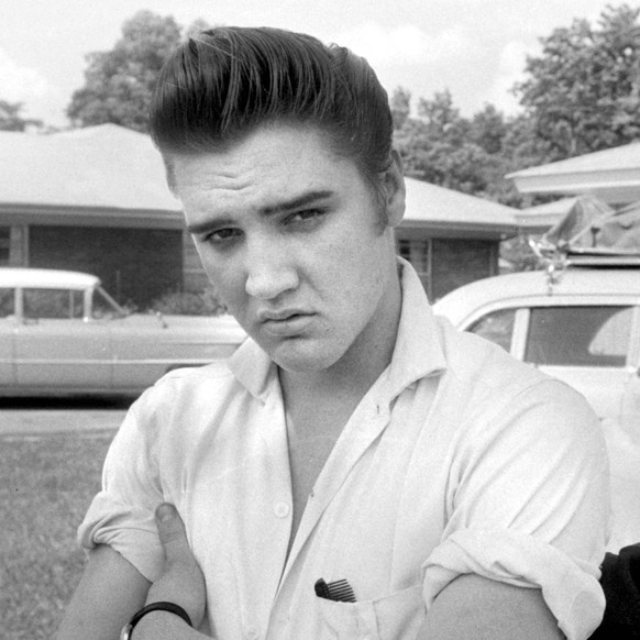Elvis Presley is seen in the front yard of his home at 1034 Audubon Drive, Memphis, Tennessee in this handout photo from 1956, courtesy of The Elvis Presley Estate. Presley would have been 80 years ol ...
