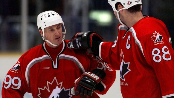 Team Canada&#039;s Wayne Gretzky, left, is congratulated by teammate Eric Lindros, right after Canada defeated the U.S. Olympic hockey team 4-1 at the Big Hat arena in Nagano Monday, Feb. 16, 1998. (K ...