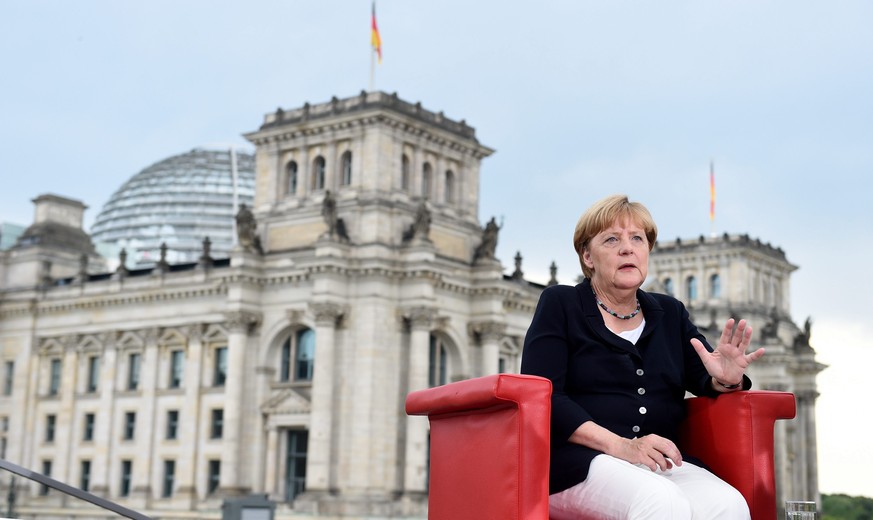 epa05513127 German Chancellor Angela Merkel is questioned during a TV interview by the ARD presenters Tina Hassel and Thomas Baumann (both not pictured) at a gallery of Elisabeth Lueders House in Berl ...