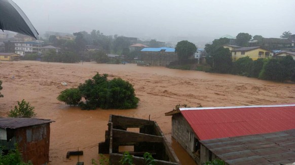 In this image made available by Society 4 Climate Change Communication, Sierra Leone, mud and water flow in Freetown Sierra Leone Monday Aug. 14, 2017. Mudslides after heavy rains and flooding killed  ...