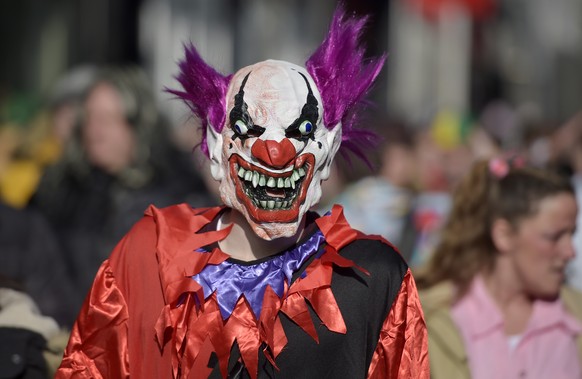 A man dressed as a horror clown is pictured when thousands of revelers dressed in carnival costumes celebrate the start of the street-carnival in Cologne, Germany, Thursday, Feb. 12, 2015. (AP Photo/M ...