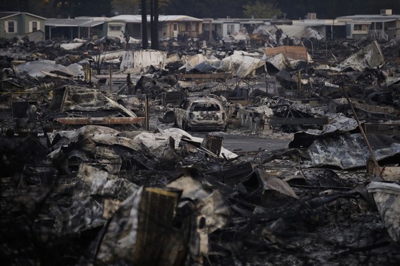 A mobile home park devastated by a wildfire is seen Friday, Oct. 13, 2017, in Santa Rosa, Calif. A fifth day of desperate firefighting in California wine country brought a glimmer of hope Friday as cr ...