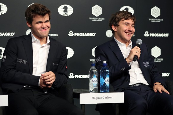 Sergey Karjakin (R) of Russia wishes World Chess Champion Magnus Carlsen a happy birthday after Karjakin&#039;s loss at the 2016 World Chess Championship match in New York, U.S., November 30, 2016. RE ...