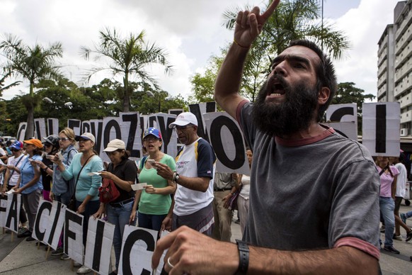 epa06141365 A demonstrator shouts slogans during an opposition protest against the Government in Caracas, Venezuela, 12 August 2017. Dozens of Venezuelans marched from different municipalities of the  ...