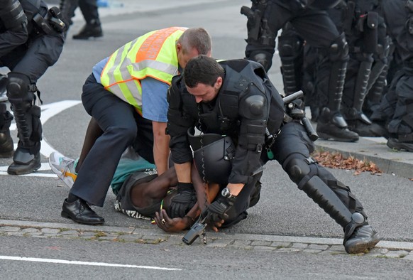 epa05540803 A picture made available on 15 September 2016 shows police officers taking a man into custody during a gathering at the Kornmarkt square in Bautzen, Germany, 10 September 2016. Participant ...