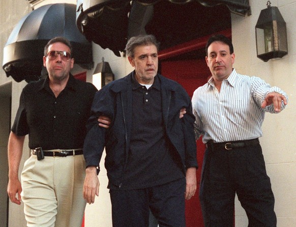 Mob boss Vincent &quot;The Chin&quot; Gigante, center, is led from his upper East side Manhattan apartment, Friday, July 11, 1997, in New York en route to U.S. District court in Brooklyn, where he is  ...