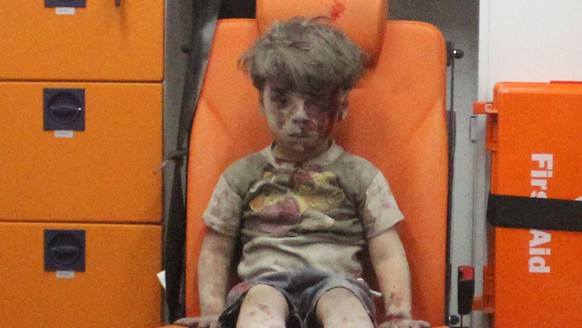 Five-year-old Omran Daqneesh, with bloodied face, sits inside an ambulance after he was rescued following an airstrike in the rebel-held al-Qaterji neighbourhood of Aleppo, Syria August 17, 2016. Pict ...