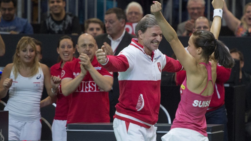 Switzerland&#039;s Viktorija Golubic, right, and team captain Heinz Guenthardt, left, celebrate her win against Karolina Pliskova of the Czech Republic, after their World Group semifinal Fed Cup tenni ...