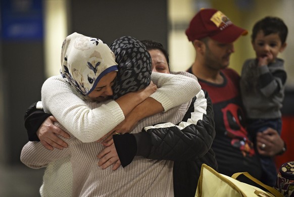 epaselect epa05772958 An Iraqi family from Woodbridge, Virginia, welcomes their grandmother at Dulles International Airport in Sterling, Virginia, USA, 05 February 2017. The grandmother, who holds a U ...