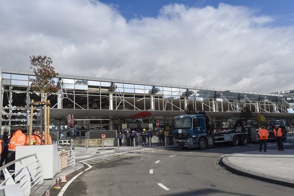 epa05227685 Exterior view on the damaged departure hall at Brussels Airport, in Zaventem, Belgium, 23 March 2016. At least 31 people were killed with hundreds injured in terror attacks in Brussels, Be ...