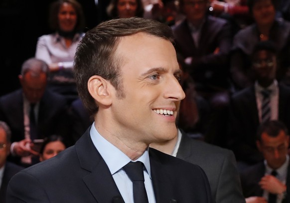 Independent centrist presidential candidate for the presidential election Emmanuel Macron smiles prior to a television debate at French TV station TF1 in Aubervilliers, outside Paris, France, Monday,  ...