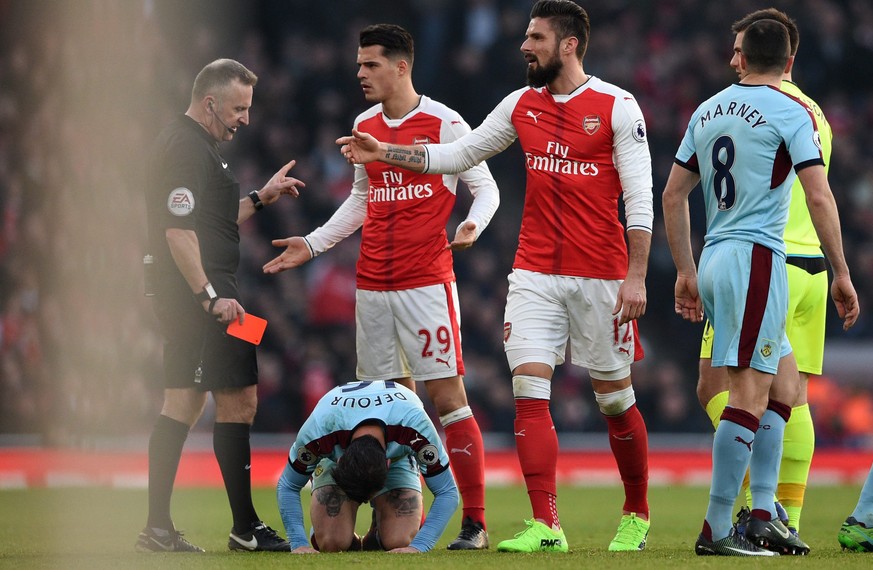 epa05742039 Arsenal Granit Xhaka (C) is being sent off by referee Jon Moss against Burnley during the English Premier League game between Arsenal and Burnley at Emirates Stadium in London, Britain, 22 ...