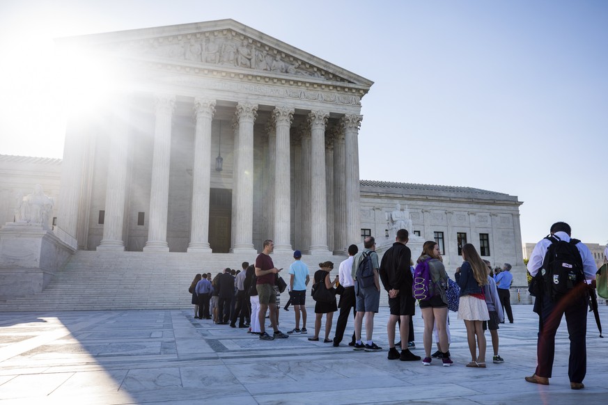 epa06051310 People gather outside the Supreme Court where the justices are expected to deliver a much-anticipated ruling on US President Donald J. Trump&#039;s travel ban on visitors to the US from si ...