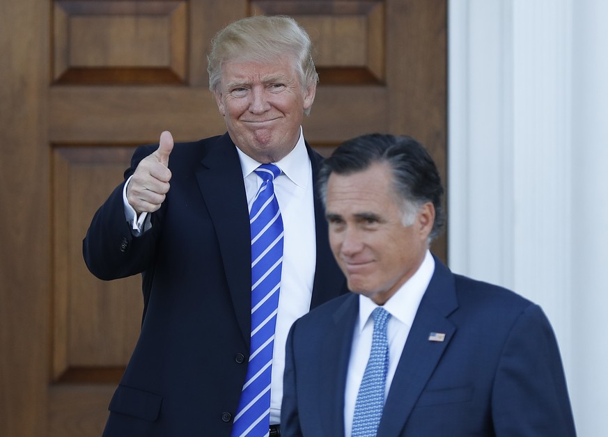 President-elect Donald Trump gives the thumbs-up as Mitt Romney leaves Trump National Golf Club Bedminster in Bedminster, N.J., Saturday, Nov. 19, 2016. (AP Photo/Carolyn Kaster)