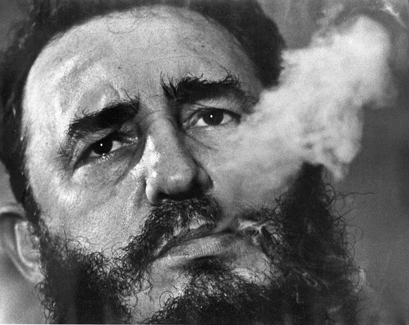 FILE - In this March 1985 file photo, Cuban Prime Minister Fidel Castro exhales cigar smoke during an interview at his presidential palace in Havana, Cuba. Castro, a Havana attorney who fought for the ...