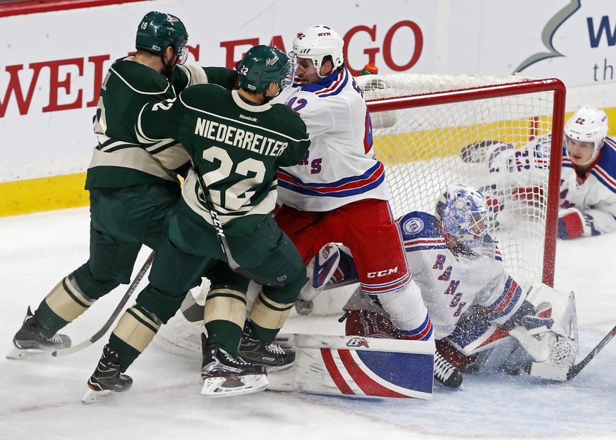 New York Rangers&#039; Brendan Smith keeps Minnesota Wild&#039;s Nino Niederreiter and Martin Hanzal, left, at bay after Rangers goalie goalie Antti Raanta stopped a shot during the first period of an ...