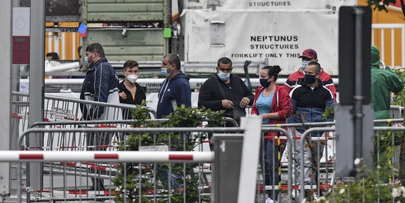 Workers arrive at a test station at the reopened Toennies meatpacking plant, Europe&#039;s biggest slaughterhouse, in Rheda-Wiedenbrueck, Germany, Thursday, July 16, 2020. The slaughterhouse was close ...