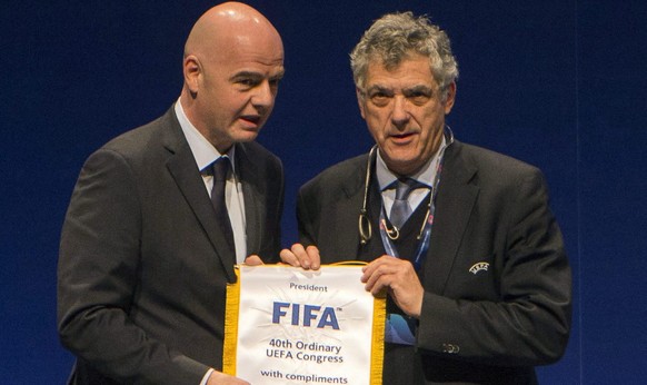 FIFA President Gianni Infantino, left, and UEFA First Vice President Angel Maria Villar Llona hold a FIFA flag during the 40th Ordinary UEFA Congress in Budapest, Hungary, Tuesday, May 3, 2016. (Tibor ...
