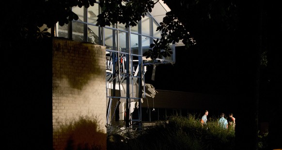 Police and firefighters inspect the scene of a blast at a sports complex in Chimay, Belgium, Friday, Aug. 26, 2016. One person is reported to have been killed and at least two injured in an accidental ...