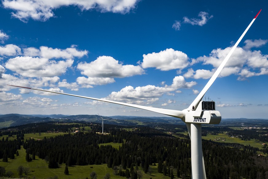 Pierre Berger, JUVENT employee in charge of security and maintenance stand on a wind turbine of 150m overall height at the JUVENT power plant on the Mont-Soleil in Saint-Imier, Switzerland on Wednesda ...