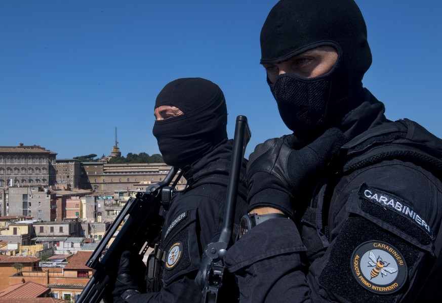 FILE - In this Tuesday, Aug. 9, 2016 file photo, Carabinieri (Italian paramilitary police) special unit&#039;s officers patrol the area next to St. Peter&#039;s Basilica, background left, in Rome. For ...