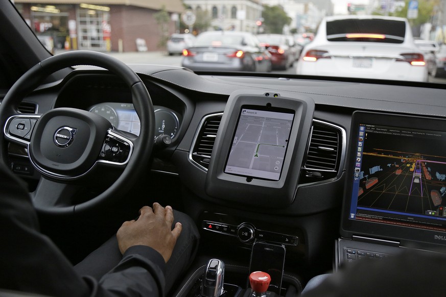 FILE - In this Tuesday, Dec. 13, 2016 file photo, an Uber car in driverless mode waits in traffic during a test drive in San Francisco. Uber&#039;s self-driving cars will return to California&#039;s s ...