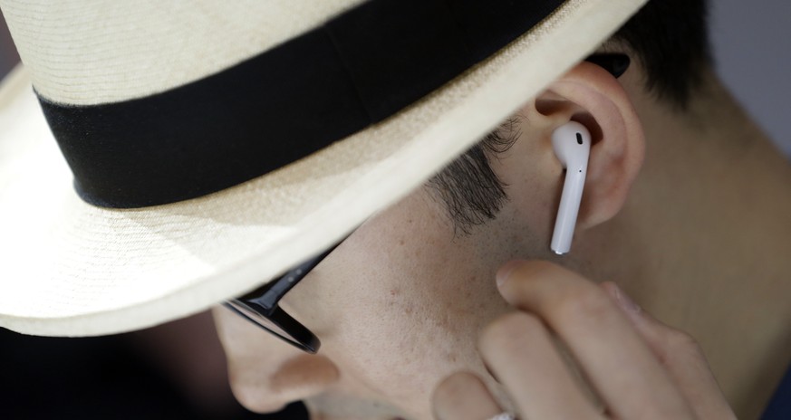 People check out the new ear buds after an event to announce new Apple products, Wednesday, Sept. 7, 2016, in San Francisco. (AP Photo/Marcio Jose Sanchez)