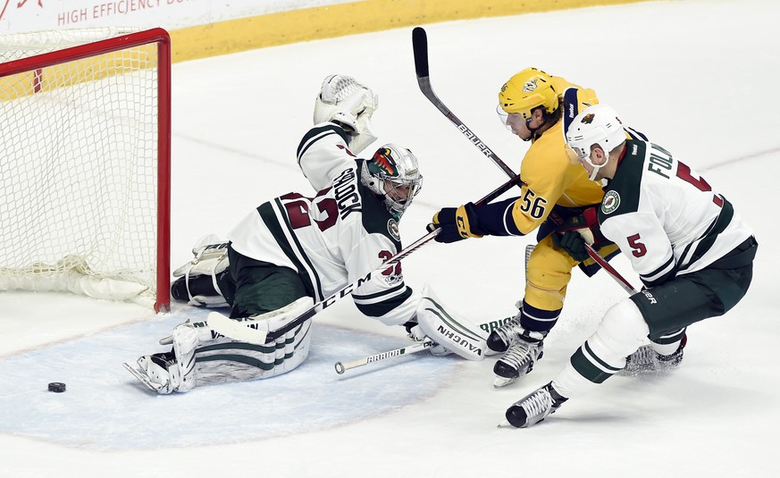 Nashville Predators left wing Kevin Fiala (56), of Czech Republic, scores a goal past Minnesota Wild goalie Alex Stalock (32) as defenseman Christian Folin (5), of Sweden, defends during the second pe ...