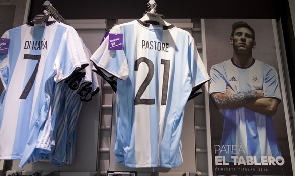 A publicity poster of Argentine soccer star Lionel Messi reading in Spanish &quot;kick the board&quot; which means &quot;rip it up and start over&quot; is seen beside Argentina national team jerseys w ...