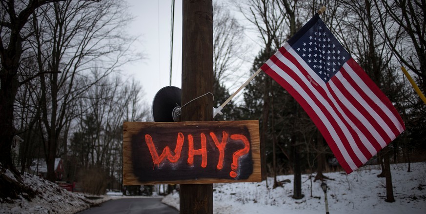 FILE PHOTO: A sign is posted on an electricity pole outside a house near Sandy Hook Elementary School, nearly two weeks after a gunman shot dead 20 students and six adults, in Newtown, Connecticut Dec ...