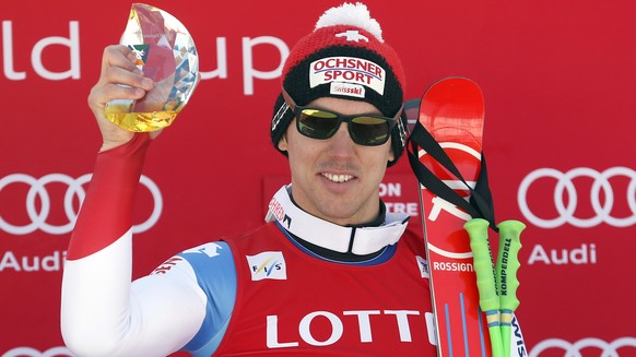 Winner Carlo Janka of Switzerland holds his trophy during the award ceremony for a men&#039;s World Cup super-G race, also a test event for the Pyeongchang 2018 Winter Olympics, at the Jeongseon Alpin ...