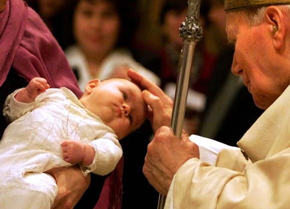 Pope Pope John Paul II baptizes Faustine Frichot of France during a special Baptism ceremony in the Sistine Chapel at the Vatican, Sunday January 13, 2002. The 81-year Pontiff baptized 20 children. (K ...