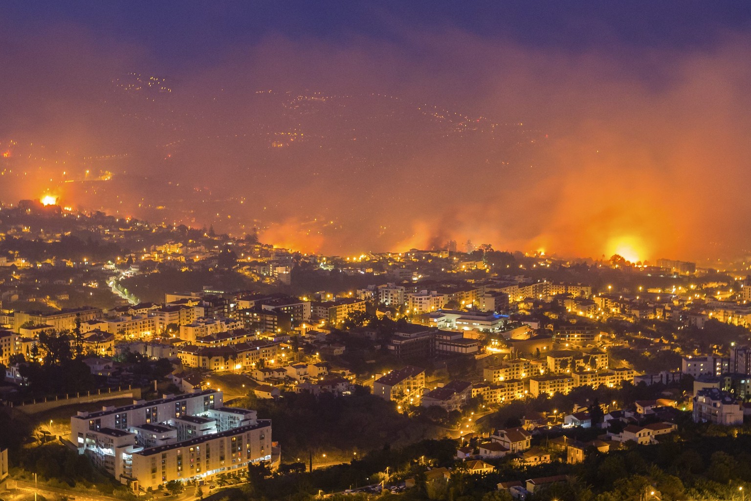 epa05469099 Forest fire in Funchal, Madeira Island, Portugal, 09 August 2016. The fire has led to the evacuation of 400 people. Portugal remains on high alert as a wave of wildfires has swept the coun ...