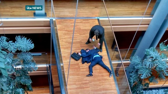 British UK Independence Party Member of the European Parliament Steven Woolfe lies on the ground after losing consciousness in the European Parliament building in Strasbourg France Thursday Oct. 6, 20 ...