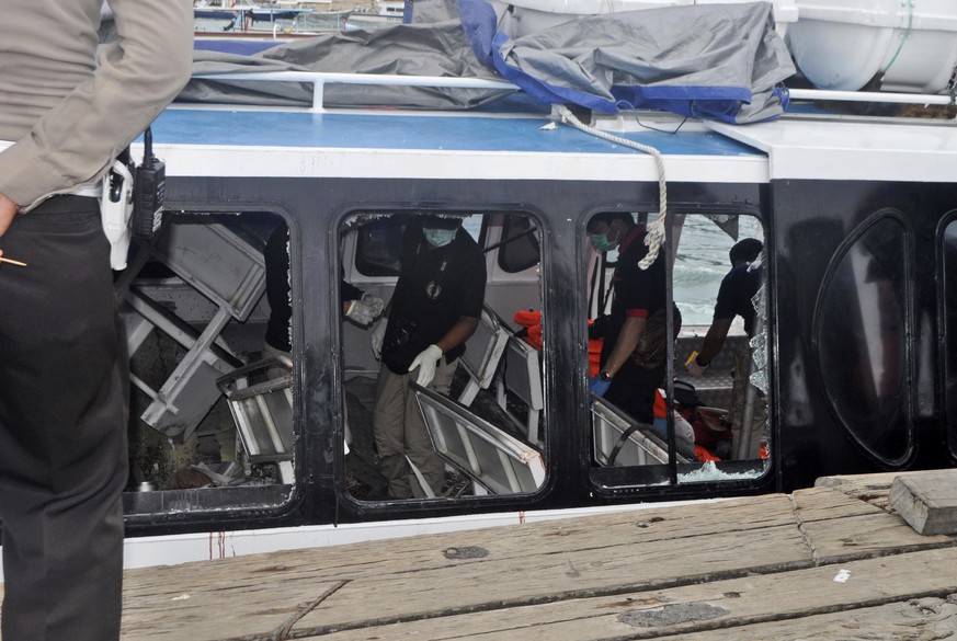 Police investigators examine the Gili Cat 2 boat following an explosion while it was enroute to nearby island of Lombok, at Padangbai Port in Karangasem, Bali, Indonesia, Thursday, Sept. 15, 2016. Pol ...