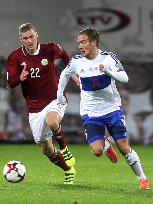 epa05575448 Vladislavs Gutkovskis (L) of Latvia and Hallur Hansson of Faroe Islands in action during the FIFA World Cup 2018 qualifying match between Latvia and Faroe Islands at the Skonto stadium in  ...