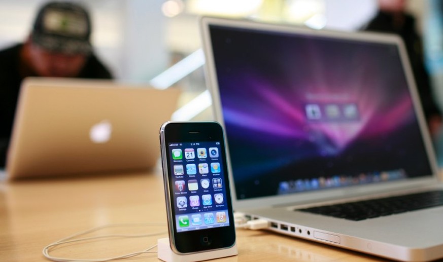 An Apple iPhone 3GS and an Apple Macbook Pro are shown at the Apple retail store in San Francisco, California July 21, 2009. Apple Inc posted a quarterly profit that blew past Wall Street forecasts th ...