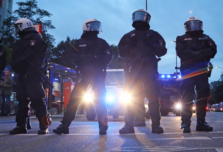 epa06066509 Riot police during protests against the G20 at the Schanzenviertel in Hamburg, northern Germany, 04 July 2017. The G20 Summit (or G-20 or Group of Twenty) is an international forum for gov ...