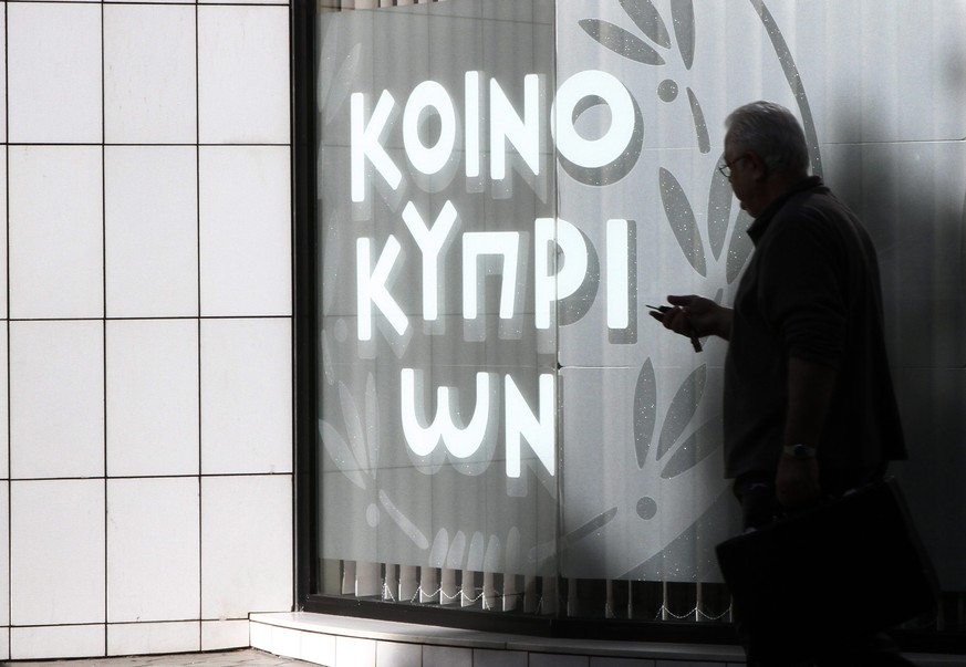 epa04531021 A man walk outside a branch of Bank of Cyprus in Nicosia,16 December 2014. The Bank of Cyprus shares begin trading ?n the Cyprus Stock Exchange and the Athens Stock Exchange today, after 2 ...